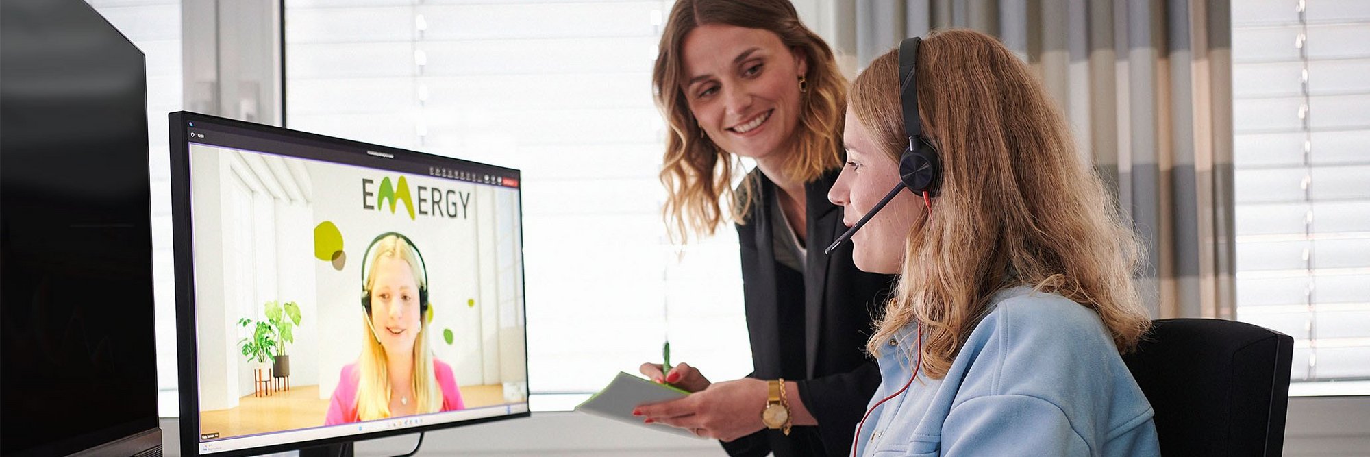 Zwei Frauen vor einem PC in einem Online-Meeting